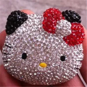 Close-up of a sparkling Hello Kitty shaped accessory covered in various rhinestones