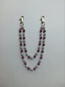 Close-up of 12mm sparkling purple and silver pave disco ball beads on a pants chain