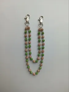 Detail of 12mm green and champagne rhinestone bead double-strand hip hop pants chain.