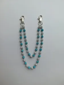 Detailed view of the double-layered blue and white rhinestone ball chain with silver clasps.