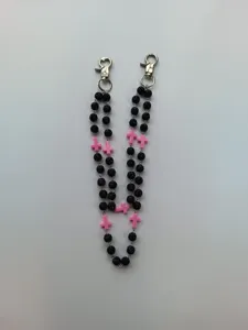 Detail showing 12mm black rhinestone beads and pink cross pendants on hip-hop pants chain