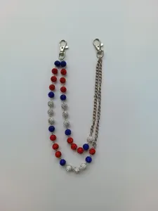 Close-up of red white and blue rhinestone balls on a silver-tone metal hip-hop pant chain