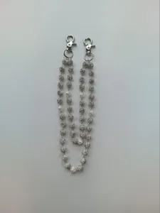 Detail of hip-hop pants chain with 12mm silver rhinestone balls and white acrylic rose beads.