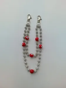 Detailed shot of hip-hop pants chain featuring silver rhinestone beads and red billiard balls