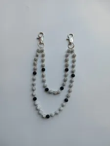 Close-up of double-strand 12mm rhinestone bead pant chain with silver metal lobster clasps