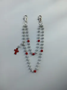 Detail of 12mm rhinestone bead pant chain featuring red cross pendant and lobster clasps