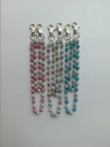 Detailed view of sparkling 12mm rhinestone disco ball chains for pants and bags.
