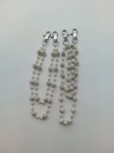 Detailed view of hip-hop waist chains with 12mm rhinestone balls and white pearls.