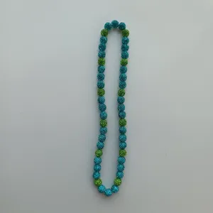 Detailed close-up of colorful rhinestone bead chain strand showcasing sparkling texture.