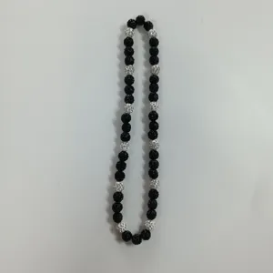 Detail view of black and white rhinestone shamballa bead necklace showcasing sparkling crystal texture.