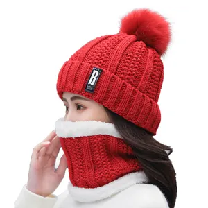 Women's winter warm red knitted beanie hat and thick neck scarf set with fleece lining.