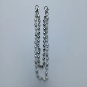 Detailed view of silver chain with 12mm rhinestone pavé balls and white pearls.