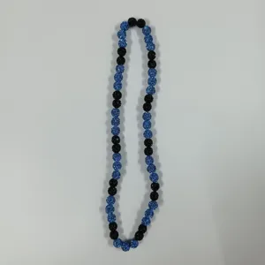 Detailed view of blue and black crystal rhinestone clay beads necklace, sparkling fashion jewelry item.