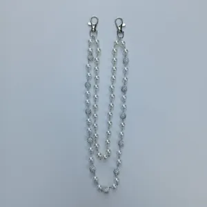 Detailed view of 12mm white pearl hip hop pant chain with sparkly rhinestone disco balls
