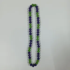Detailed close-up of purple and green rhinestone clay beads necklace, showing bead texture.