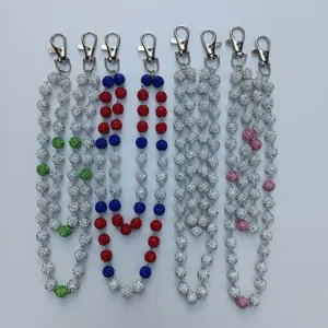 Macro view of multiple colorful 12mm sparkling rhinestone clay bead hip-hop waist chains.
