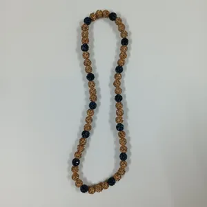 Detailed shot of the crystal clay beaded necklace featuring gold and dark blue accents.