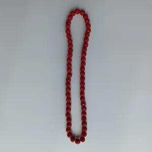 Red Shamballa rhinestone bead necklace detail, sparkly crystal clay round ball jewelry piece.