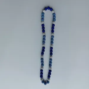 Close up detail view of sparkling rhinestone shamballa beaded necklace in blue and silver.
