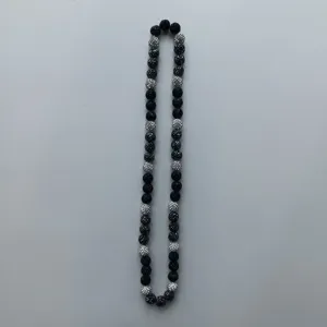 Detail view of black and rhinestone disco ball beads necklace, stylish accessory for daily wear.