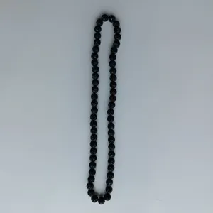 Detail shot of black rhinestone clay bead strand accessory showing texture and sparkle quality.