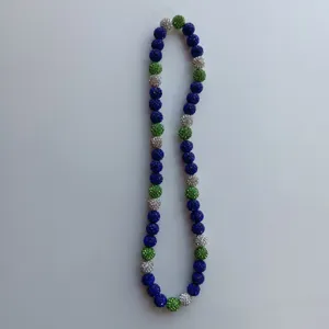Detailed closeup of colorful shamballa rhinestone crystal beaded necklace, sparkling clay balls.