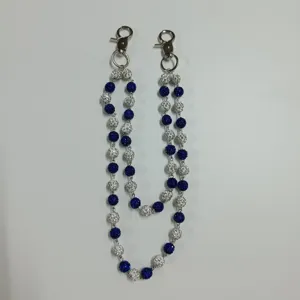 Detailed close-up view of 12mm blue and white rhinestone disco ball pants chain accessory