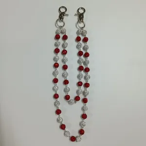 Close-up of red and white pavé disco ball hip-hop waist chain with silver clasps