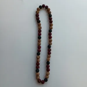 Detailed closeup view of the sparkling red, black, and gold crystal shamballa beaded necklace.