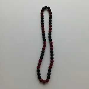 Detail shot of red and black rhinestone shamballa bead necklace, sparkling crystal clay ball design.