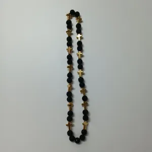 Detailed view of black beaded necklace featuring golden cross charms, hip hop fashion style.