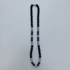 Close-up detail of black and crystal rhinestone Shamballa bead necklace with magnetic clasp.