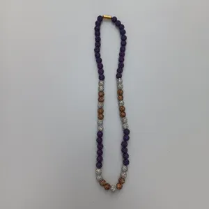 Detail shot of Shamballa style rhinestone beaded necklace with purple and bronze sparkling beads.
