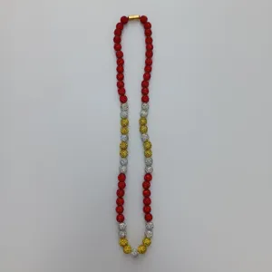 Detailed view of sparkly rhinestone clay beads necklace with red gold silver elements.