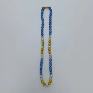 Detailed view of the sparkling Shamballa rhinestone bead necklace featuring blue and yellow crystals.