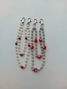 Detail view of 12mm beaded hip hop pants chains with white flowers and red billiard balls