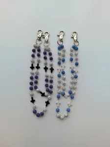 Close-up of 12mm rhinestone beaded pants chains with cross charms in purple and blue