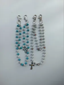 Detailed view of four 12mm rhinestone bead pant chains with metal clips and cross pendants.