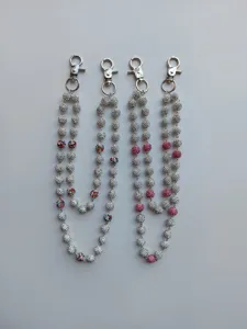 Detail view of 12mm rhinestone clay ball chains with silver metal lobster clasps.