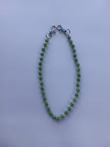 Green rhinestone Shamballa bead chain strap detail showing sparkling crystal ball design.