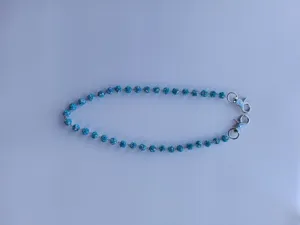 Close-up detail of the sparkling blue rhinestone ball pants chain with durable metal lobster clasps.