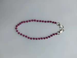 Close-up detail of the pink crystal rhinestone bead chain with silver clasps, fashion accessory.