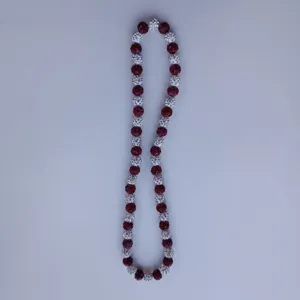 Detailed view of red and white crystal clay rhinestone shamballa bead necklace close up.