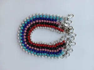 Close-up detail of colorful 12mm rhinestone ball pants chains with silver metal clasps