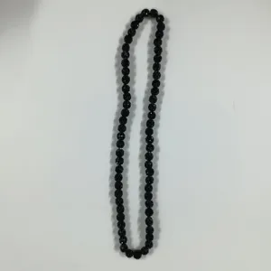Close-up detail of black rhinestone clay disco ball beads string, accessory product part.
