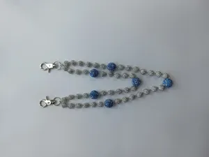 Detailed macro view of 12mm silver and blue rhinestone pavé beaded hip-hop chain