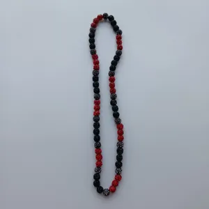 Red and black crystal disco ball Shamballa necklace detail view showing bead texture and color.