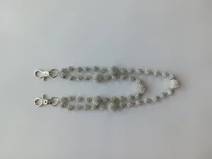 Close-up view of a silver hip-hop pant chain featuring shimmering rhinestone disco balls.
