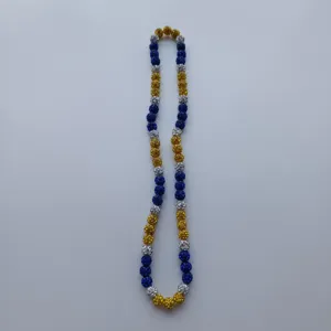 Detailed close-up of colorful rhinestone clay beads necklace with sparkling round charms.