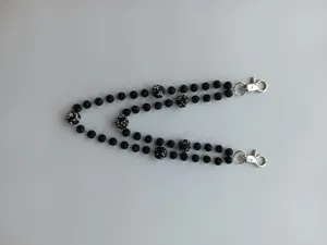 Macro detail of 12mm black pave disco ball beads and silver lobster clasps on hip hop chain